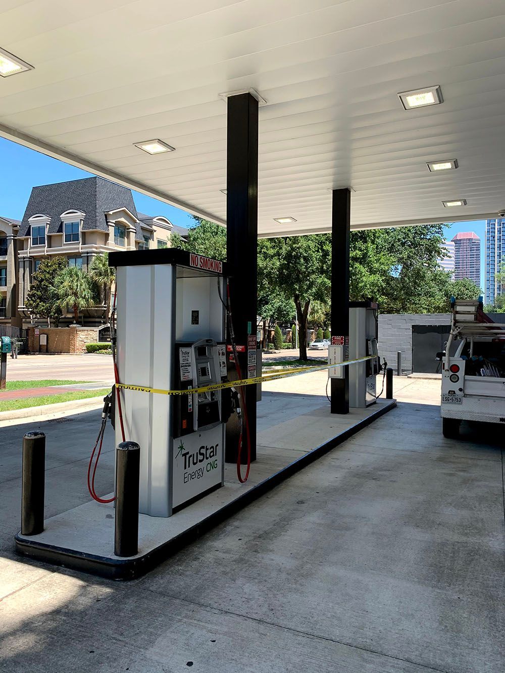 A gas station with a car parked in front of it