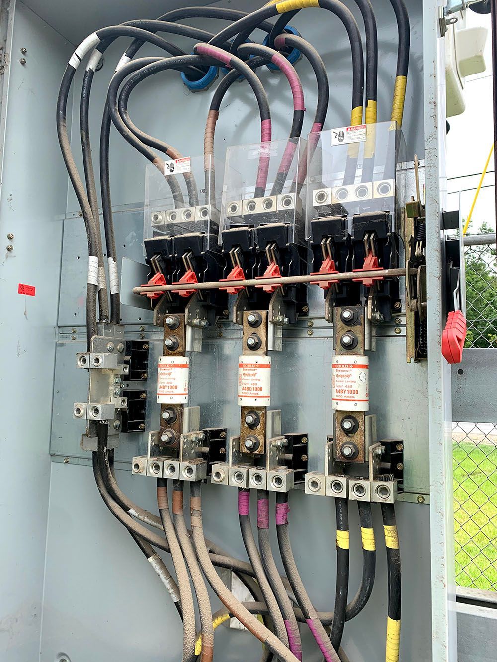 A close-up of an electrical box with a lot of wires coming out of it