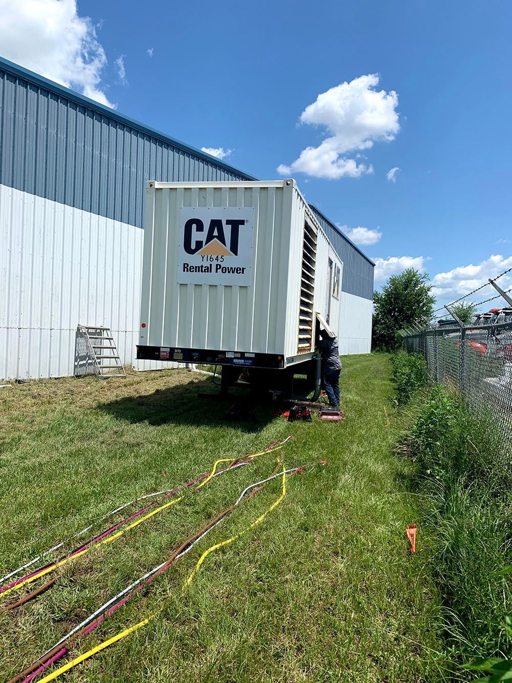 A man fixing a huge power generator