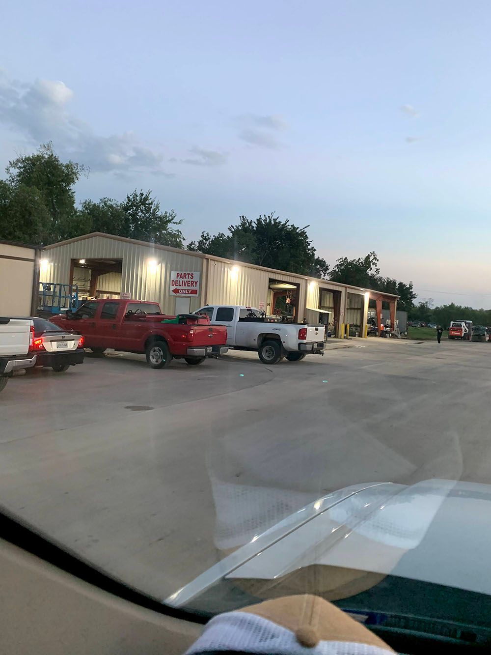 A row of trucks are parked in front of a building.