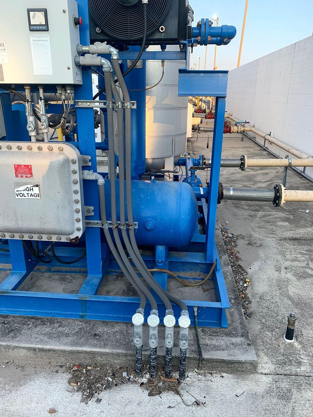 A blue machine is sitting on top of a concrete floor