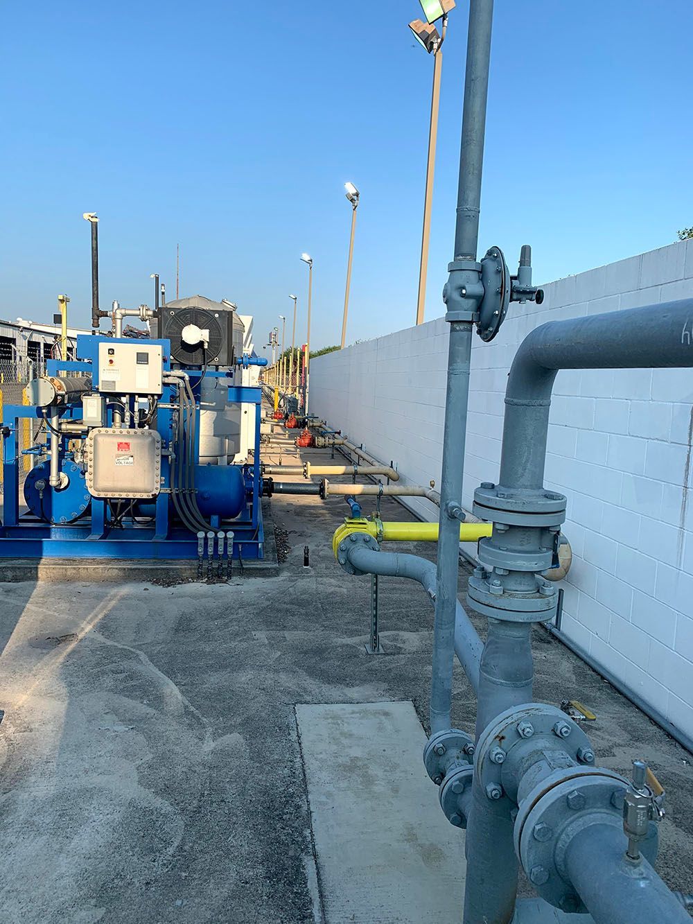 A bunch of pipes are connected to a machine in a factory