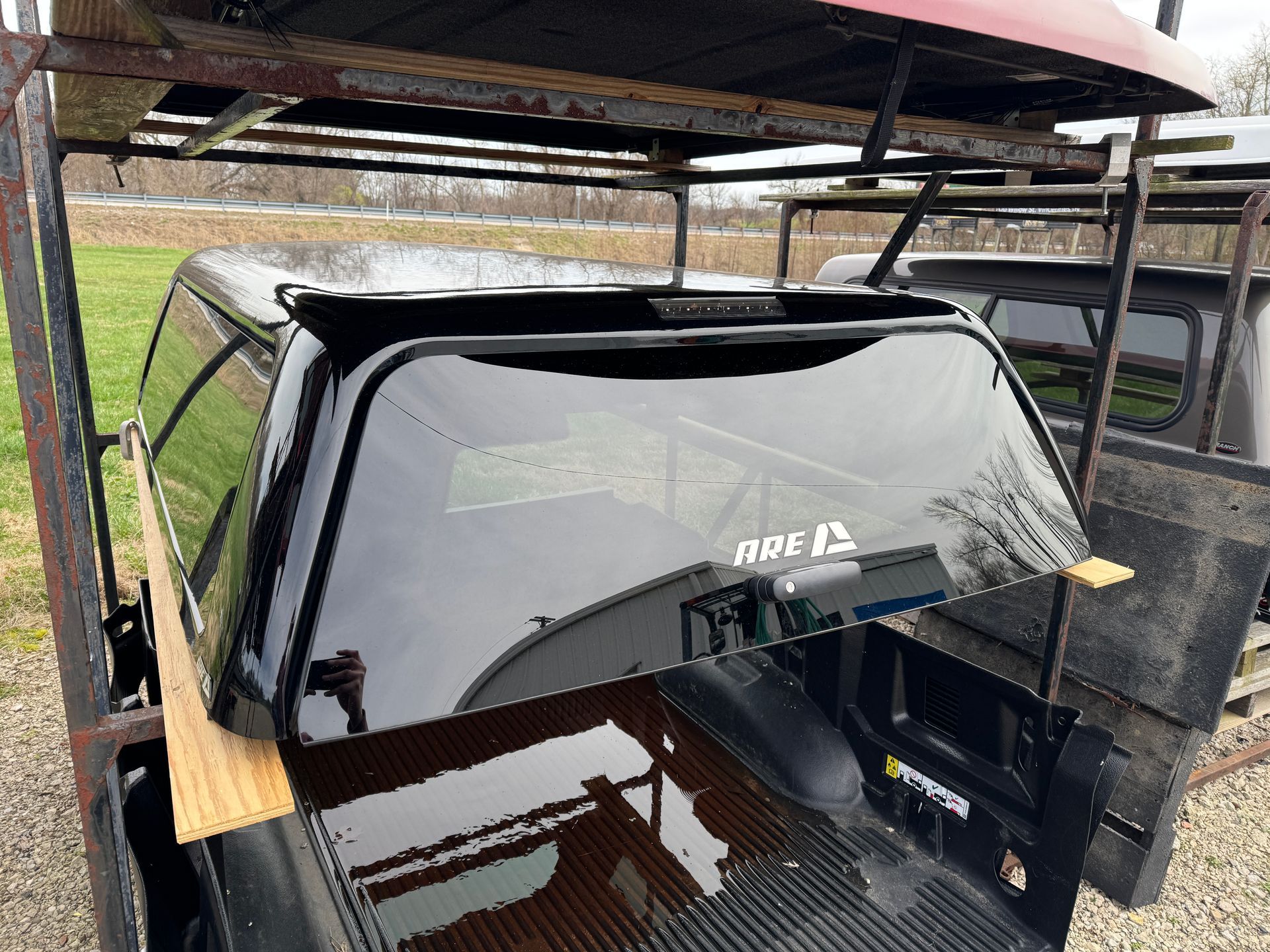 A gray, flat, square icon representing an image, featuring a simple mountain silhouette and a single dot for a sun.