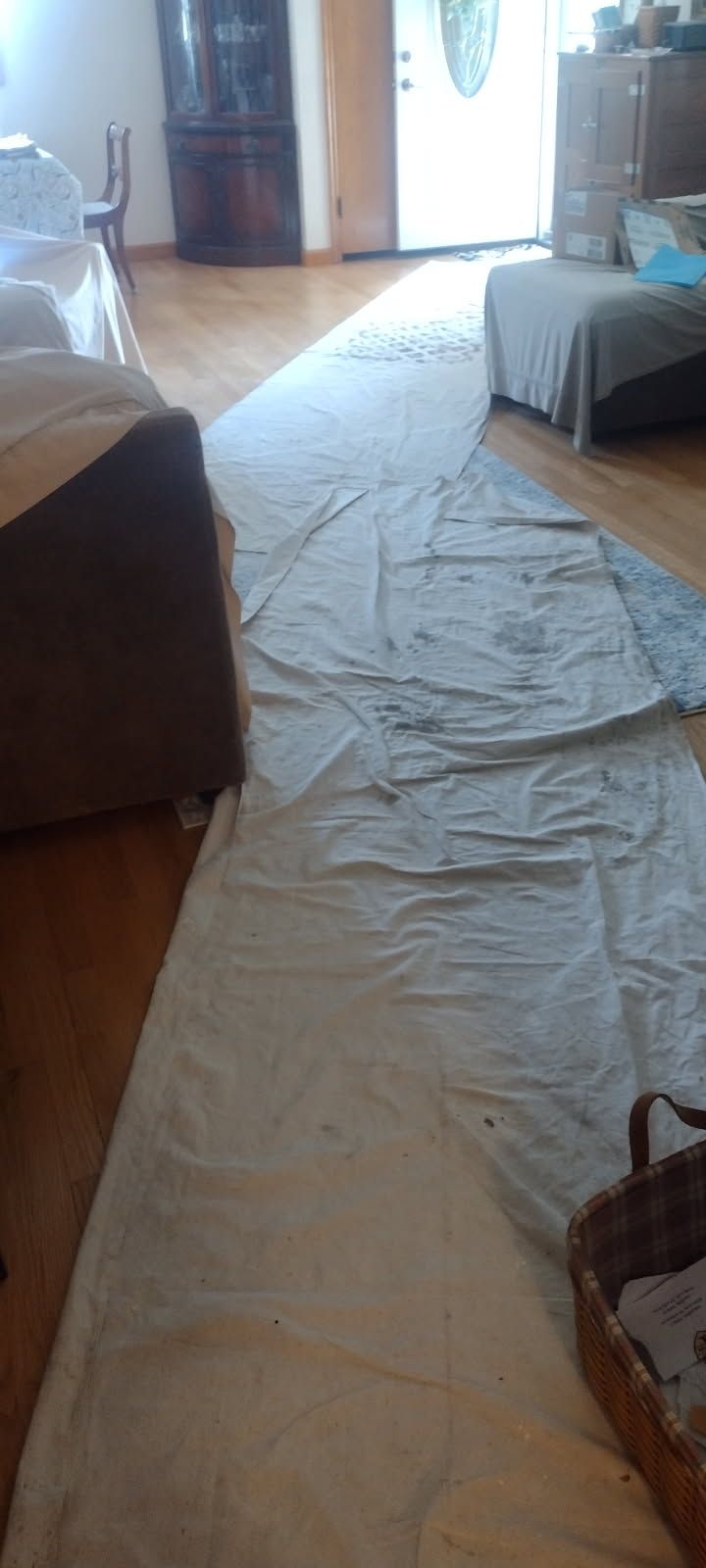 A living room with a rug on the floor and a couch.