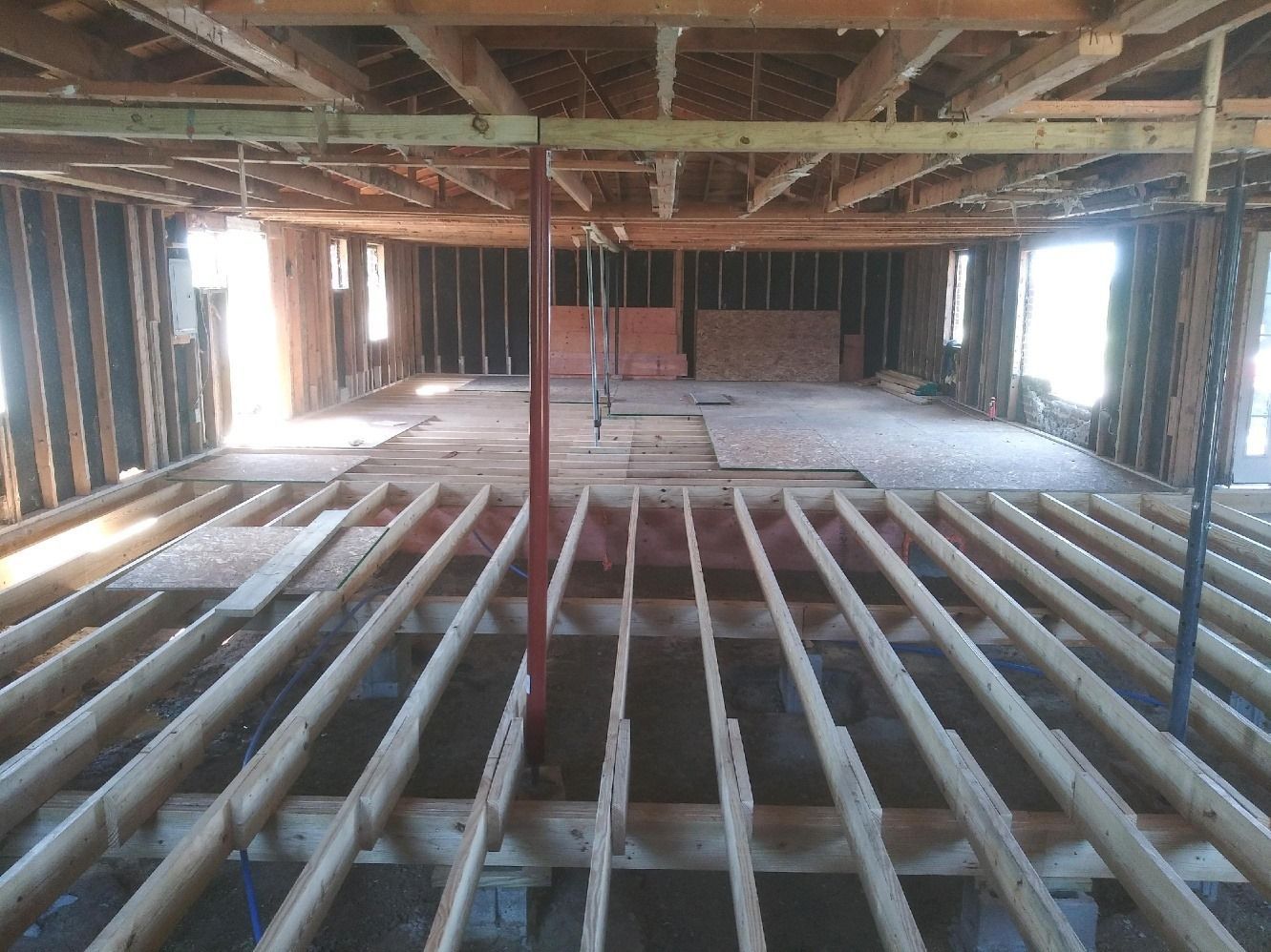 The inside of a building under construction with wooden beams