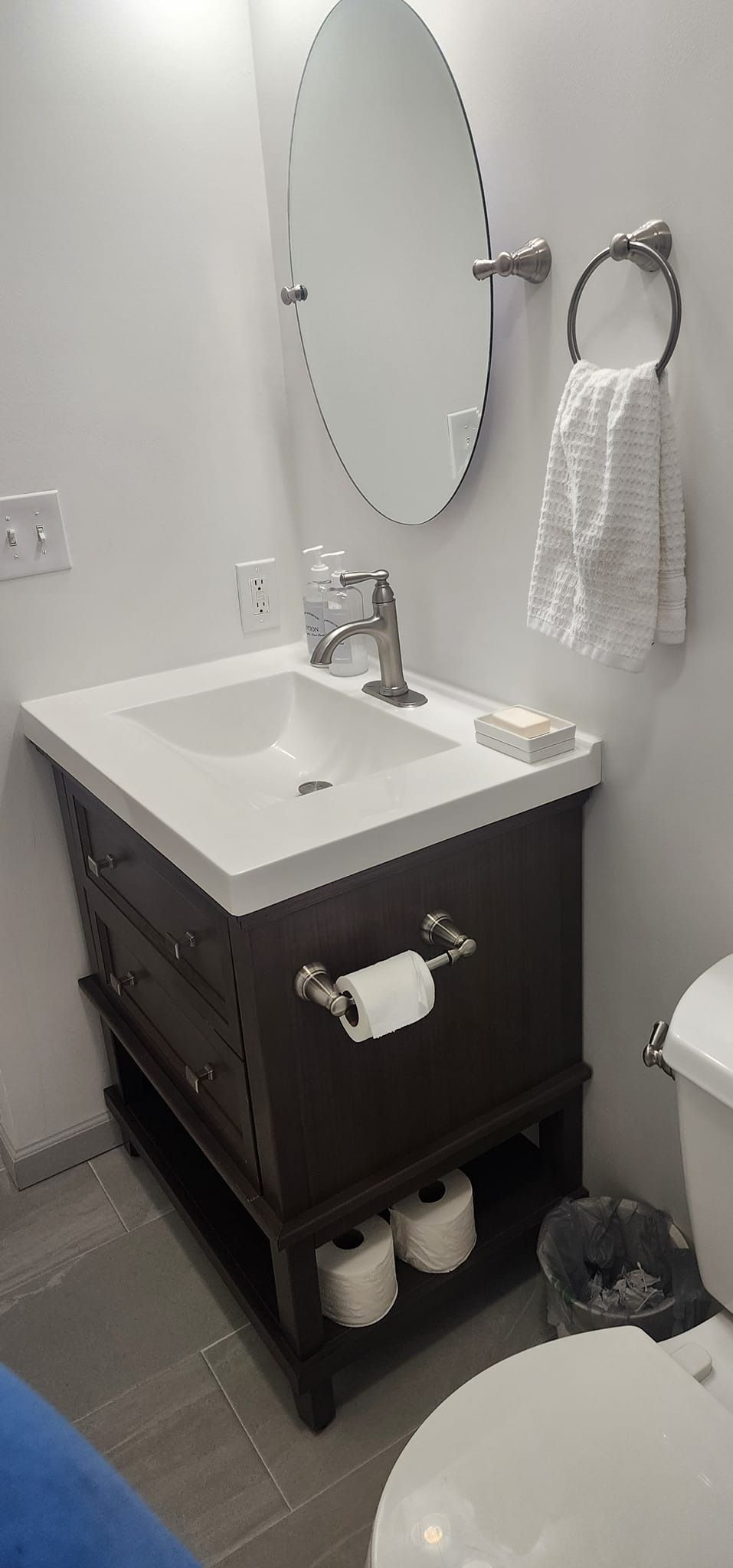 A bathroom with a sink , toilet and mirror.