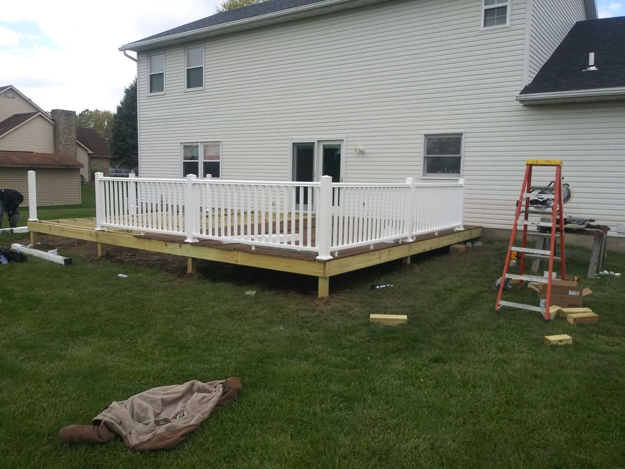 A deck is being built in the backyard of a house.