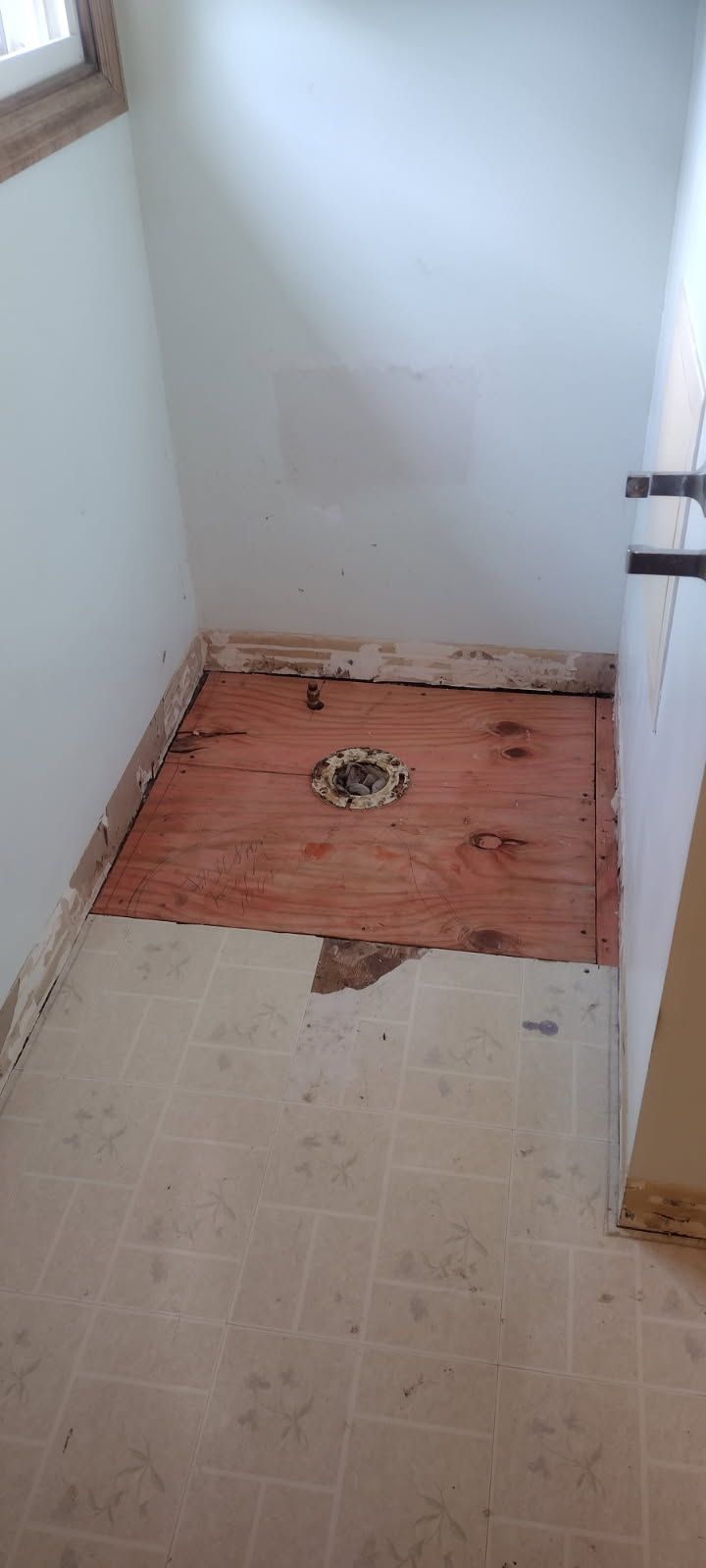 A bathroom with a wooden floor and a toilet.