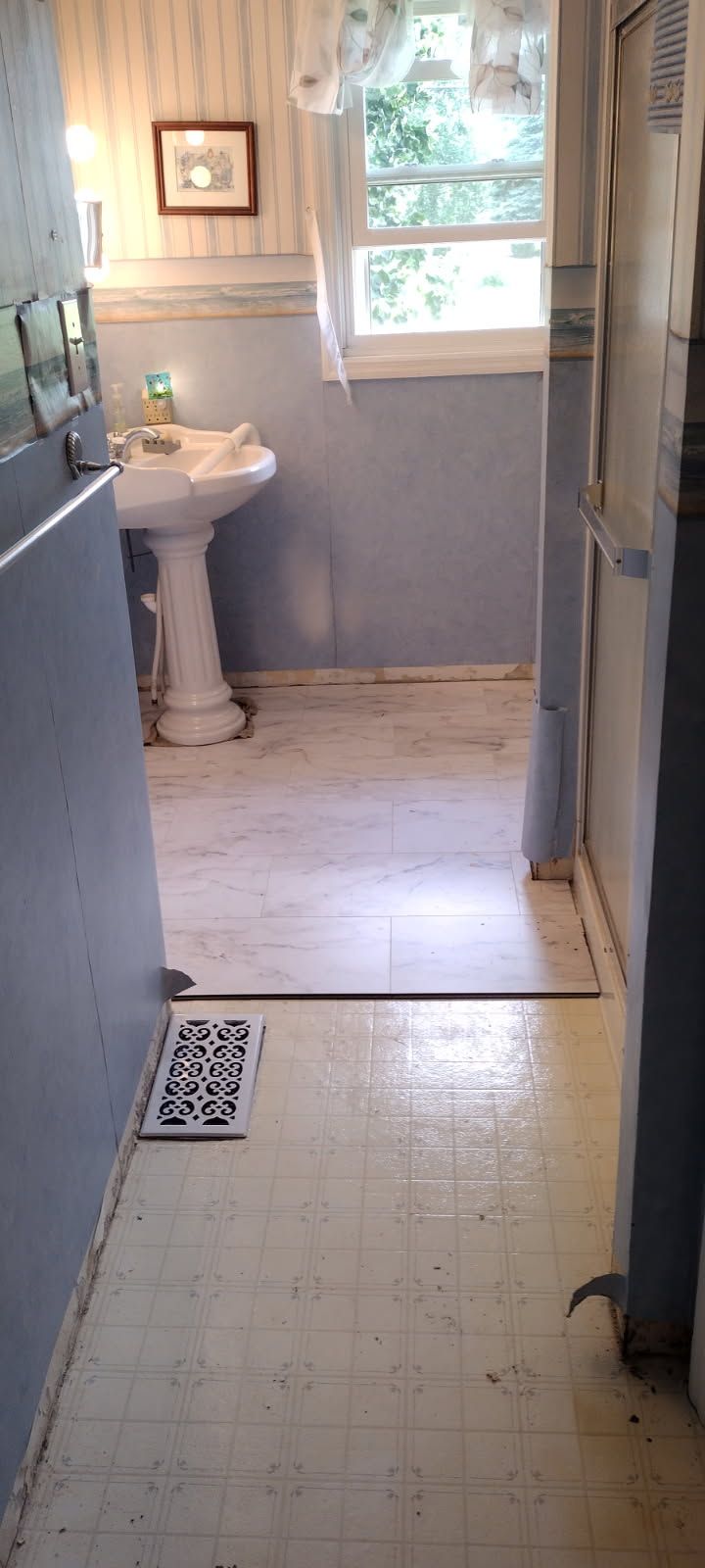 A bathroom with a sink and a window.