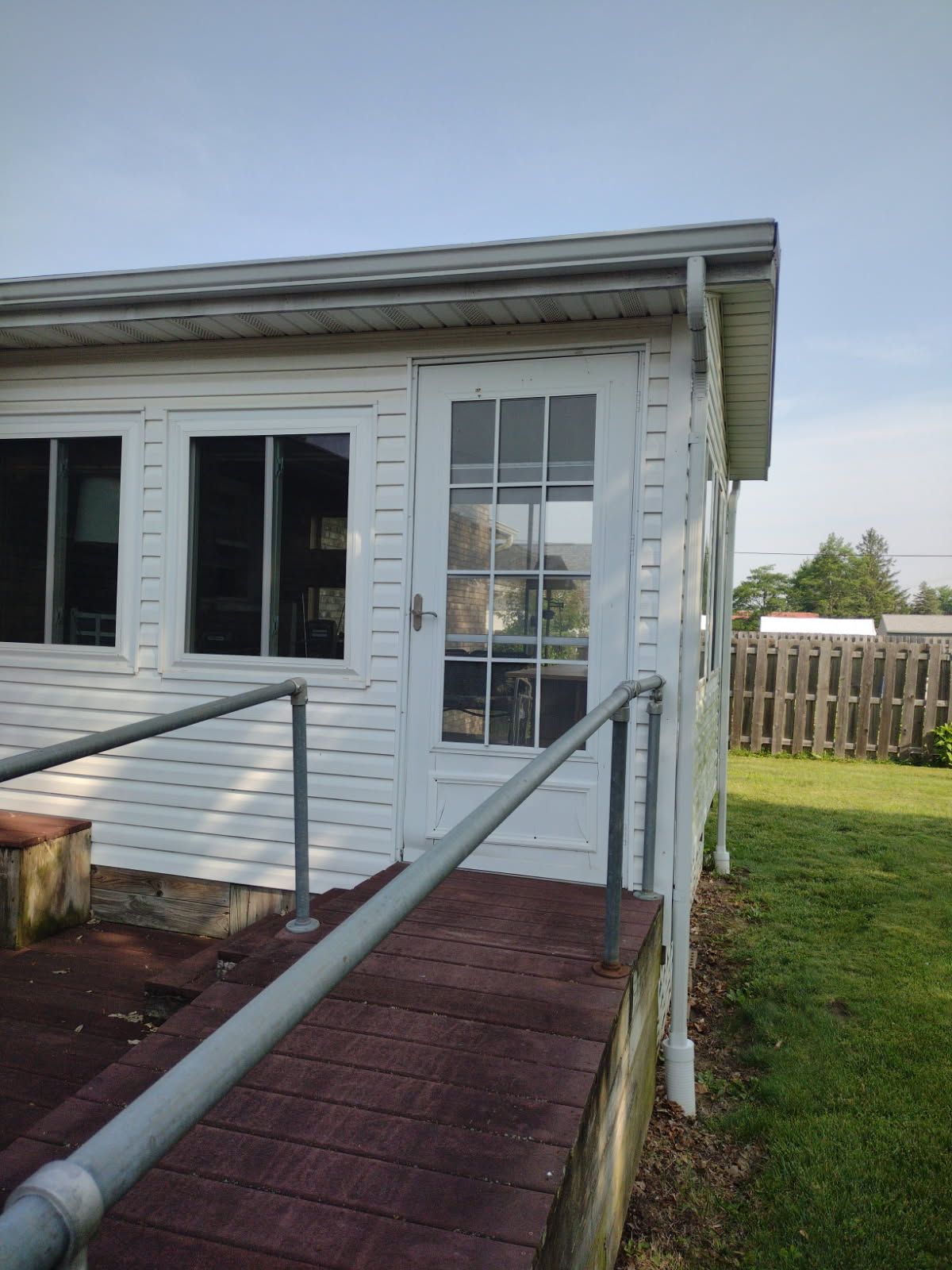 A white house with a ramp leading to the door