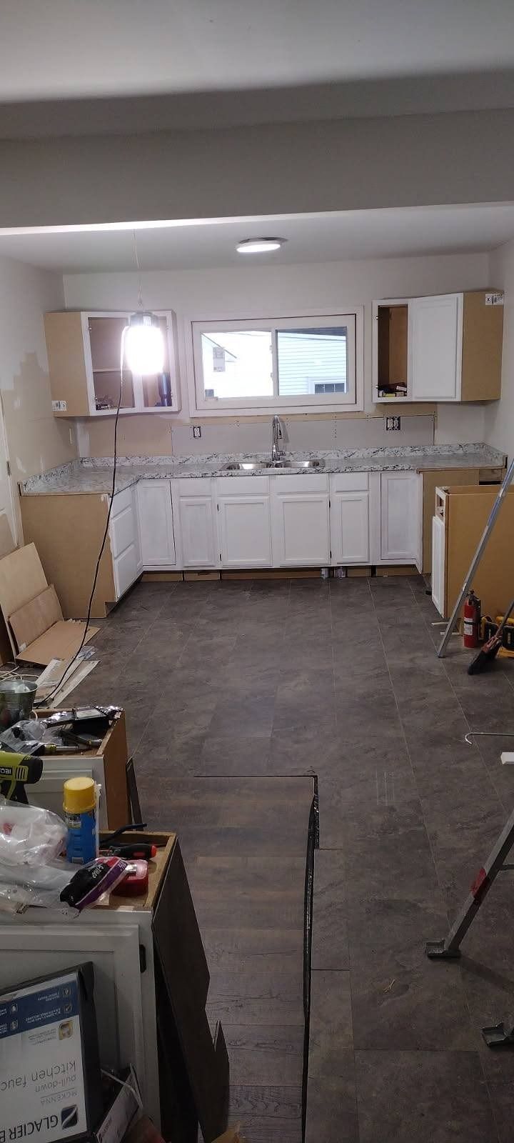A kitchen is being remodeled in a basement.