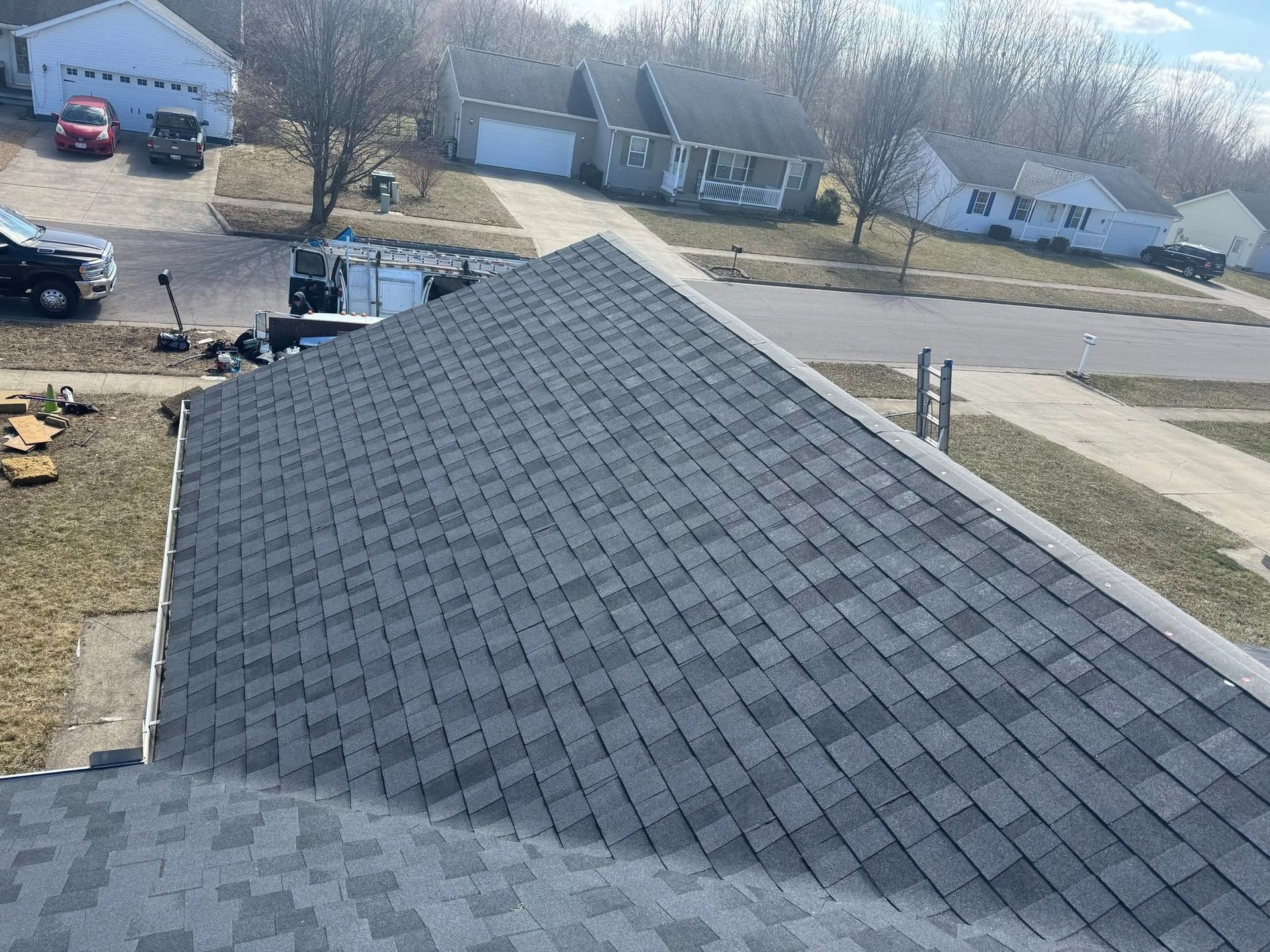 An aerial view of a roof of a house in a residential area.