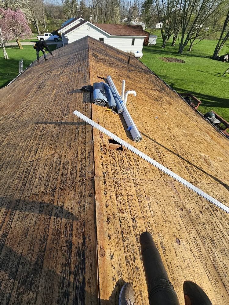 A person is standing on the roof of a house.