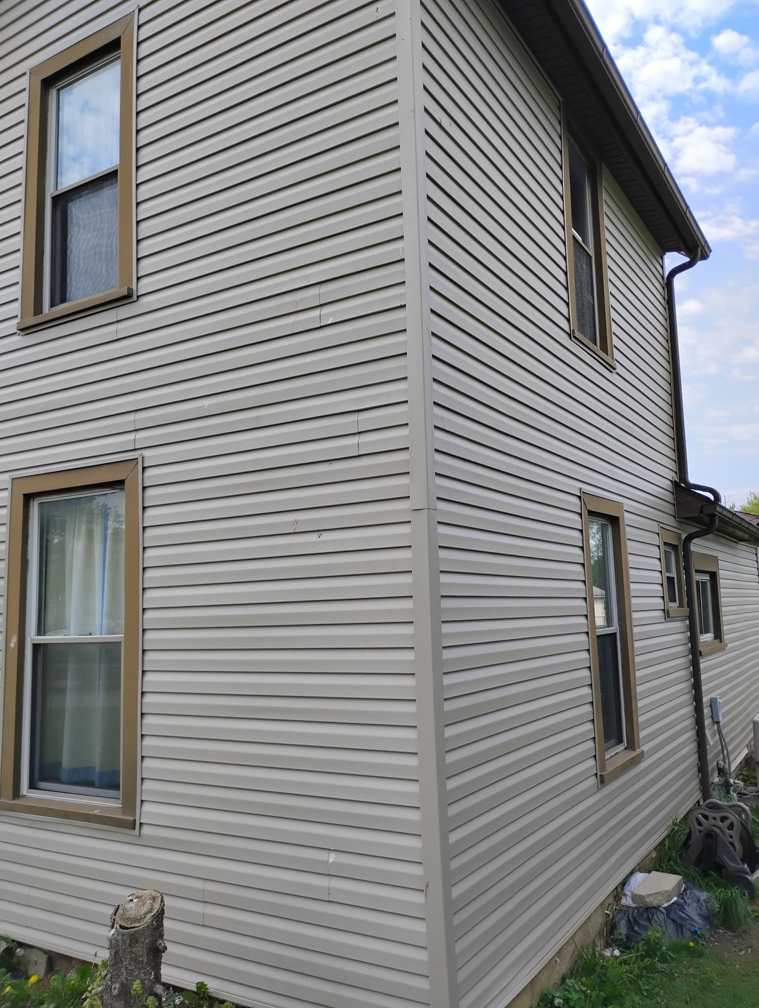 The side of a house with a lot of windows and siding.