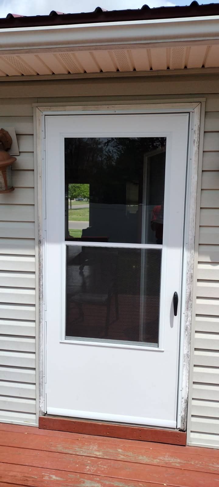 A white door with a window on the side of a house.