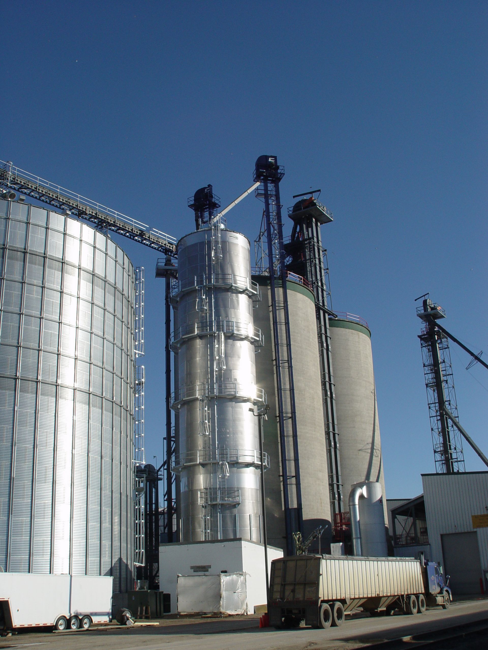 A row of silos with a blue sky in the background