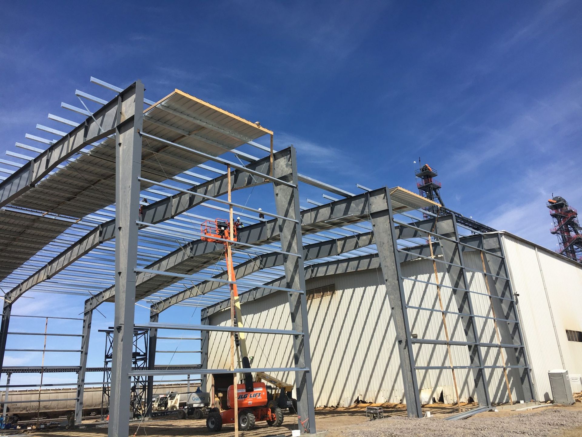 A large building under construction with a blue sky in the background.
