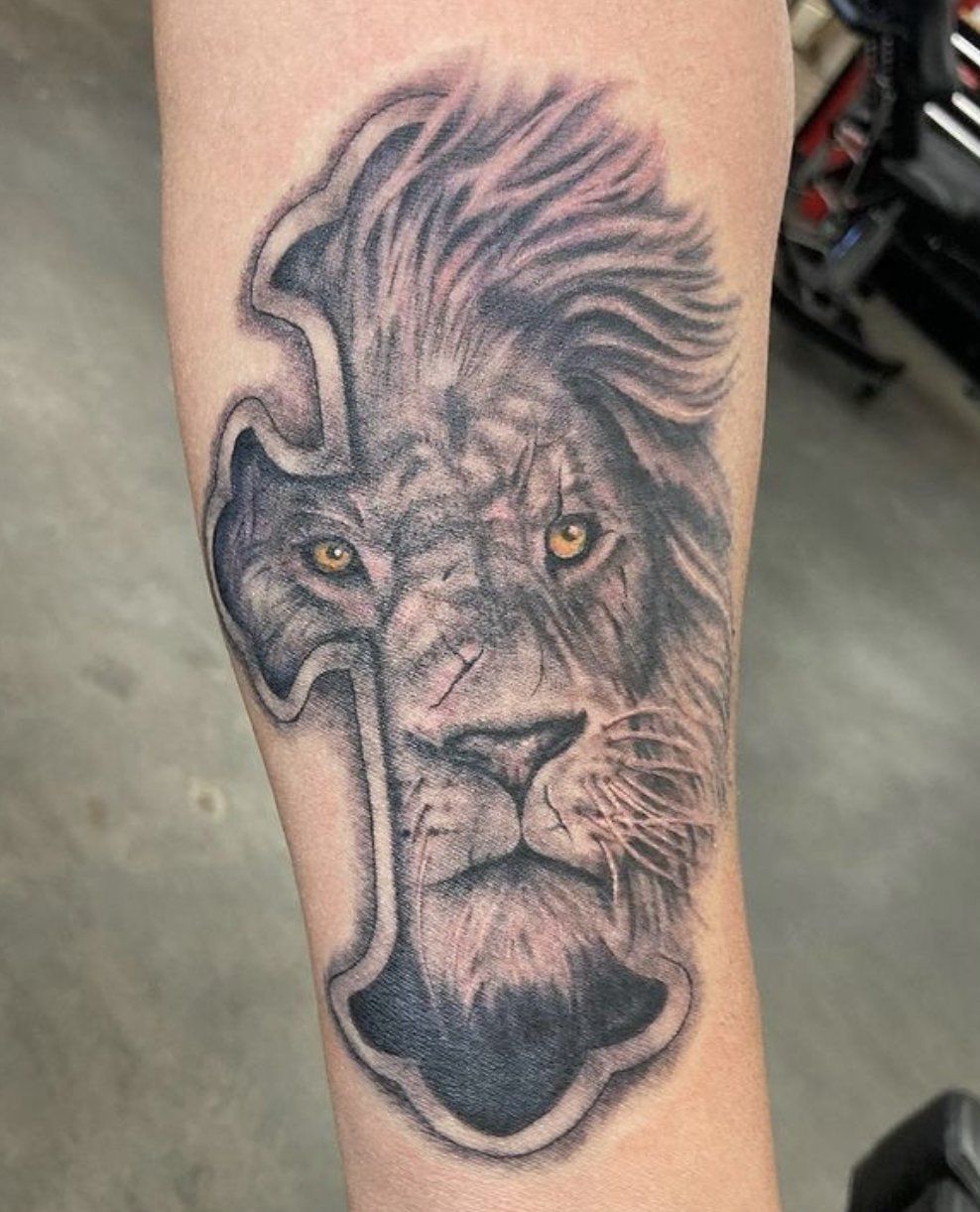 tattoo cross behind lion