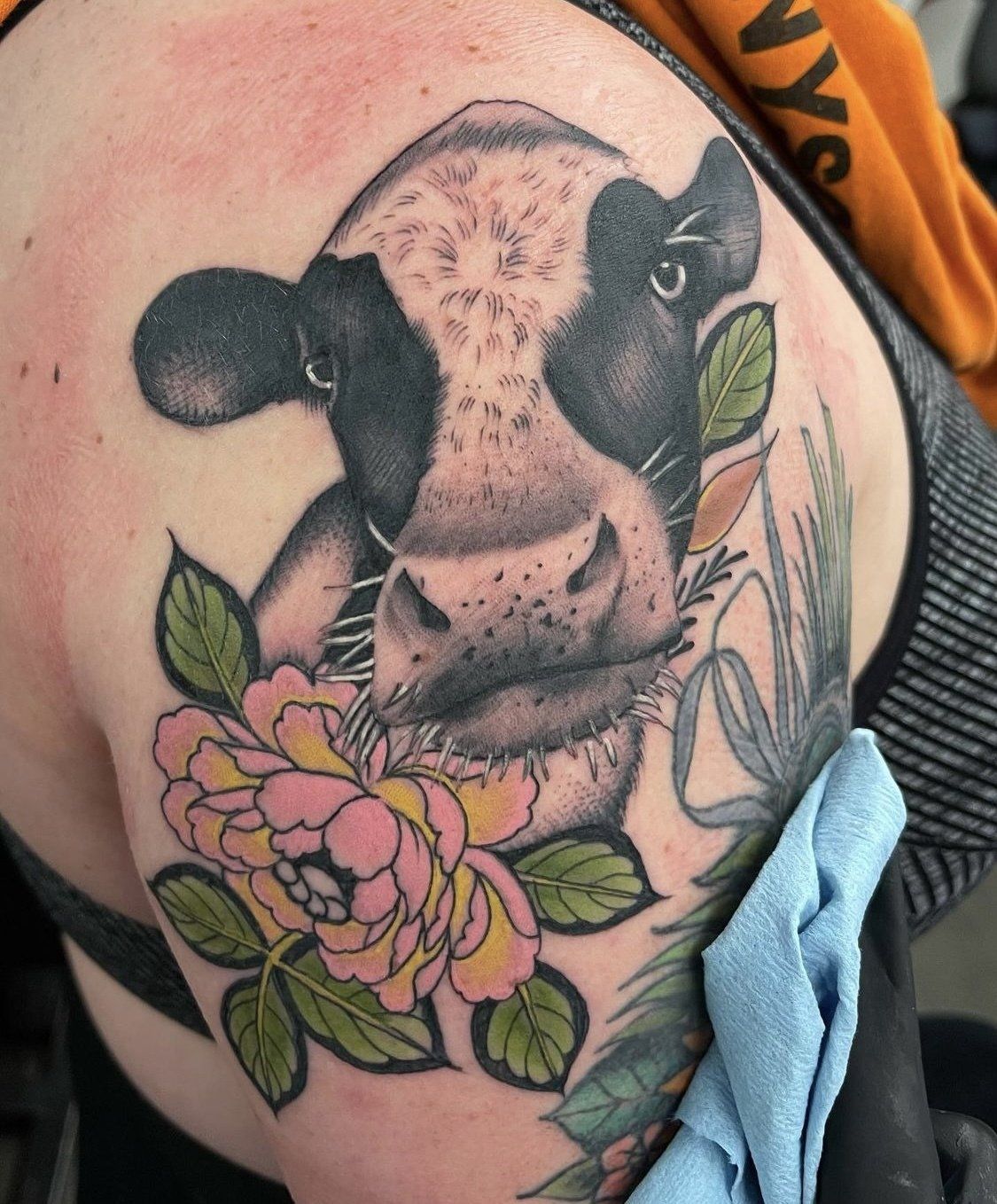 Tattoo cow face with flowers