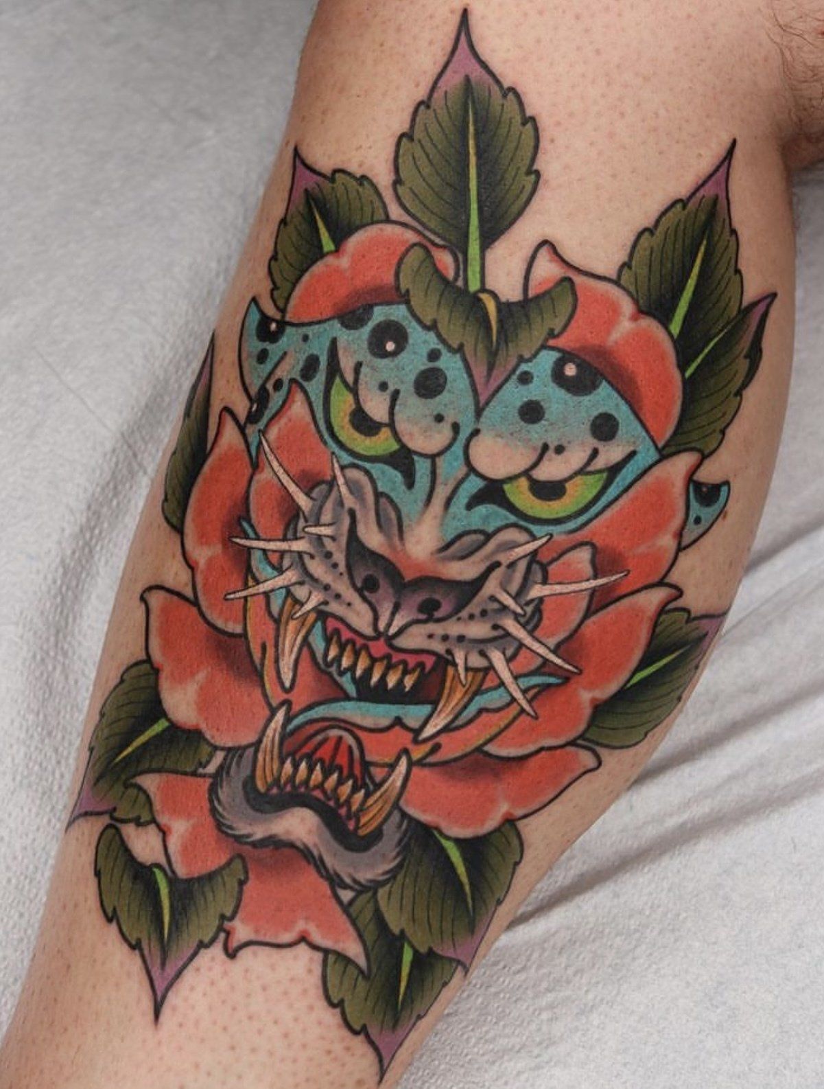 Tattoo arm tiger with fangs
