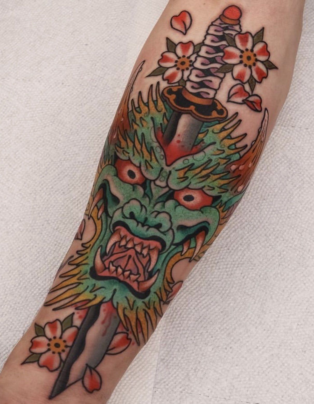 Tattoo arm dragon on sword
