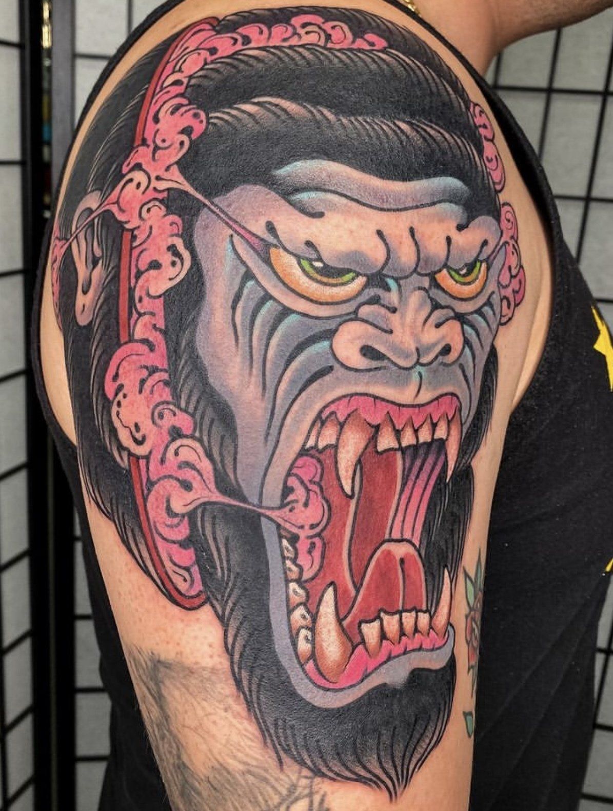 Tattoo upper arm gorilla mad face