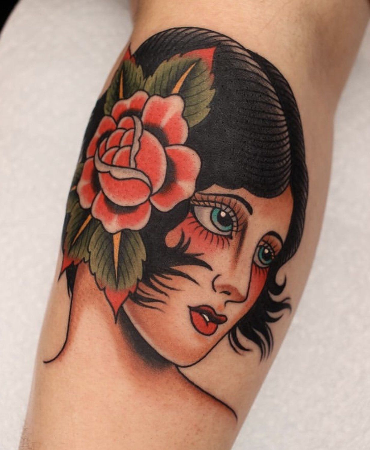Tattoo arm woman face with flowers in hair