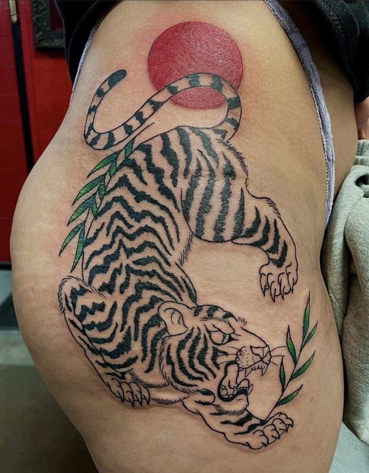 Tattoo tiger on red sun