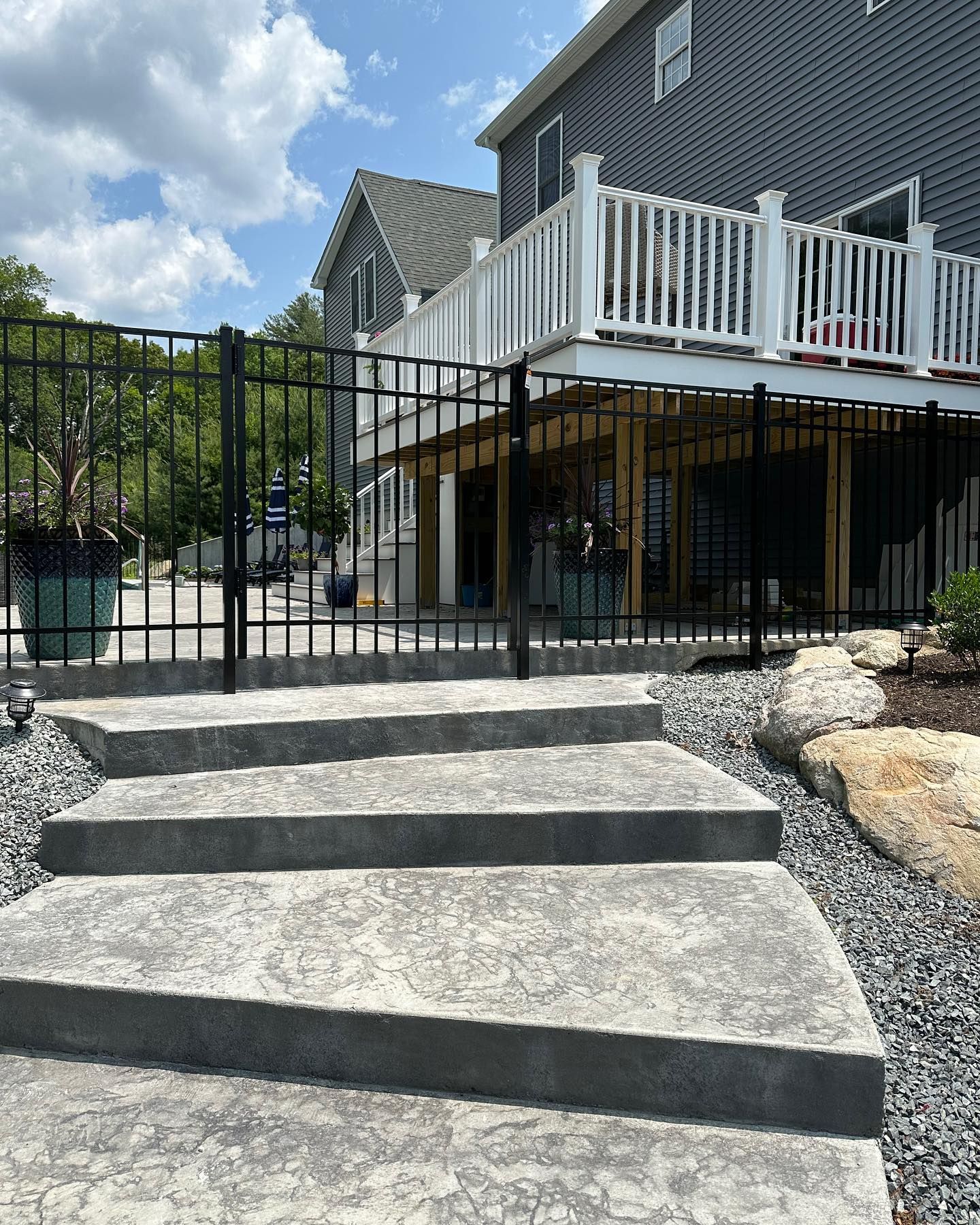 A house with a deck and stairs leading to it