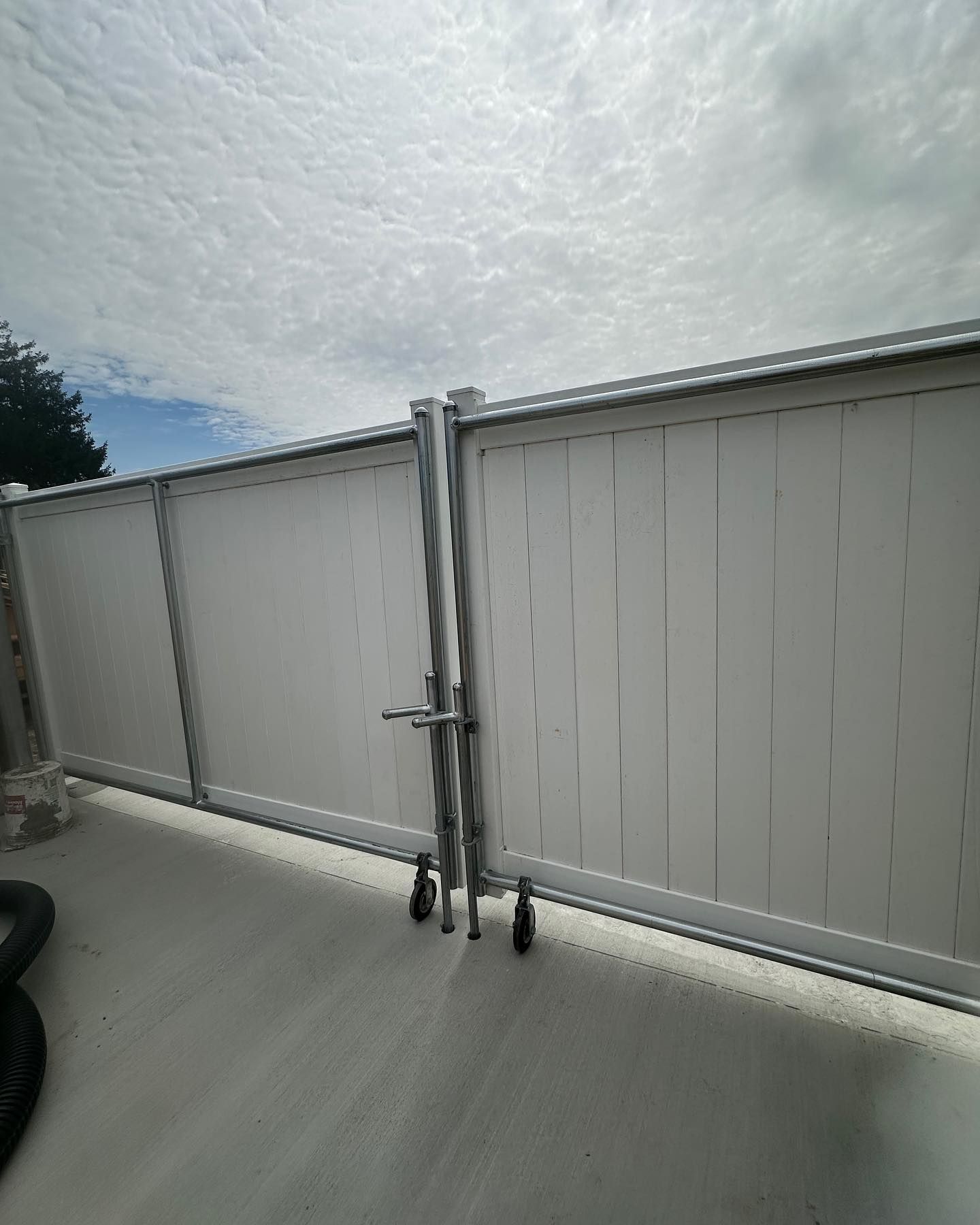 A white fence is sitting on top of a white surface.