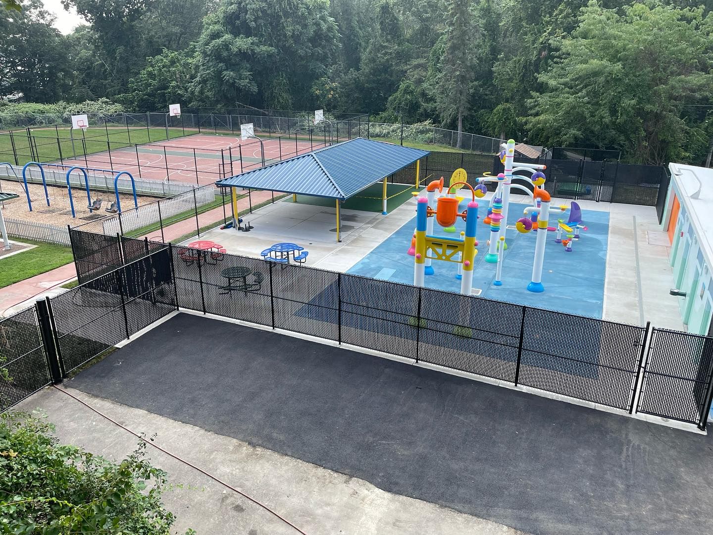 An aerial view of a water park with a fence surrounding it.