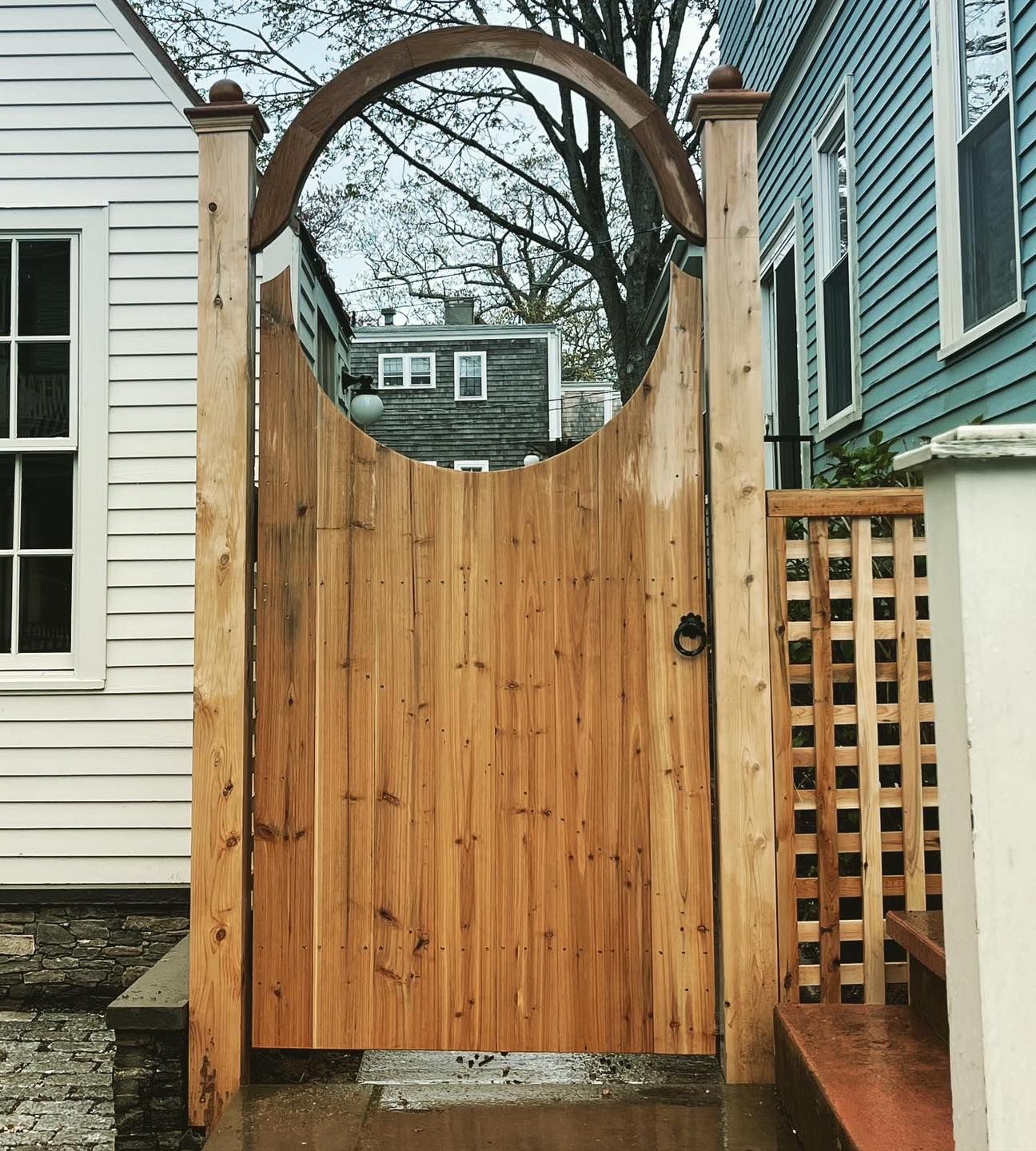 A wooden gate is in front of a house