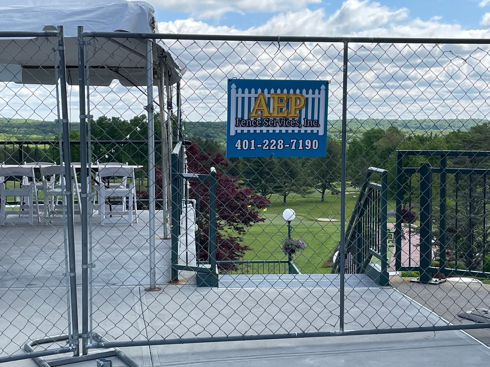 A chain link fence with a sign on it.