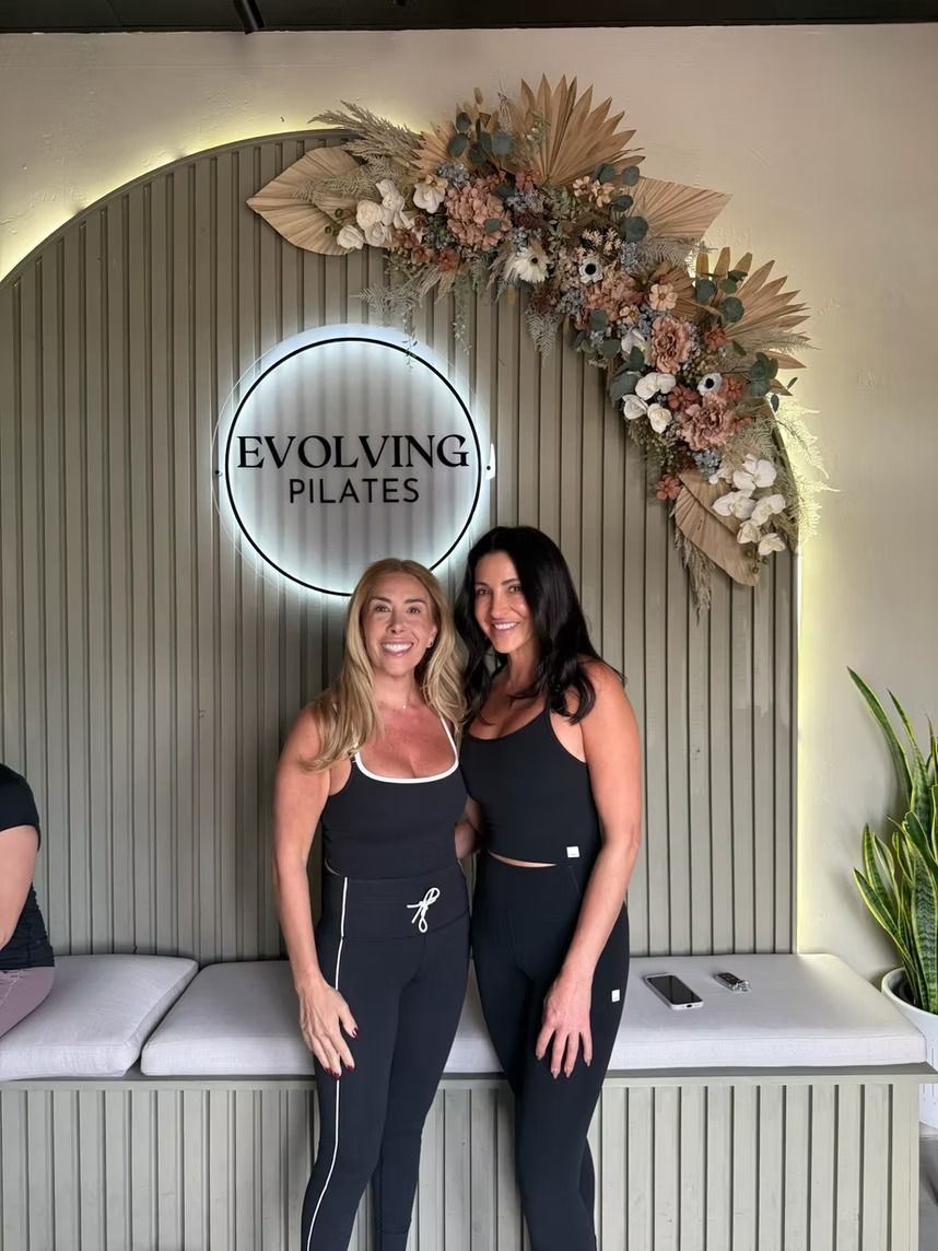 Two women posing in front of an 