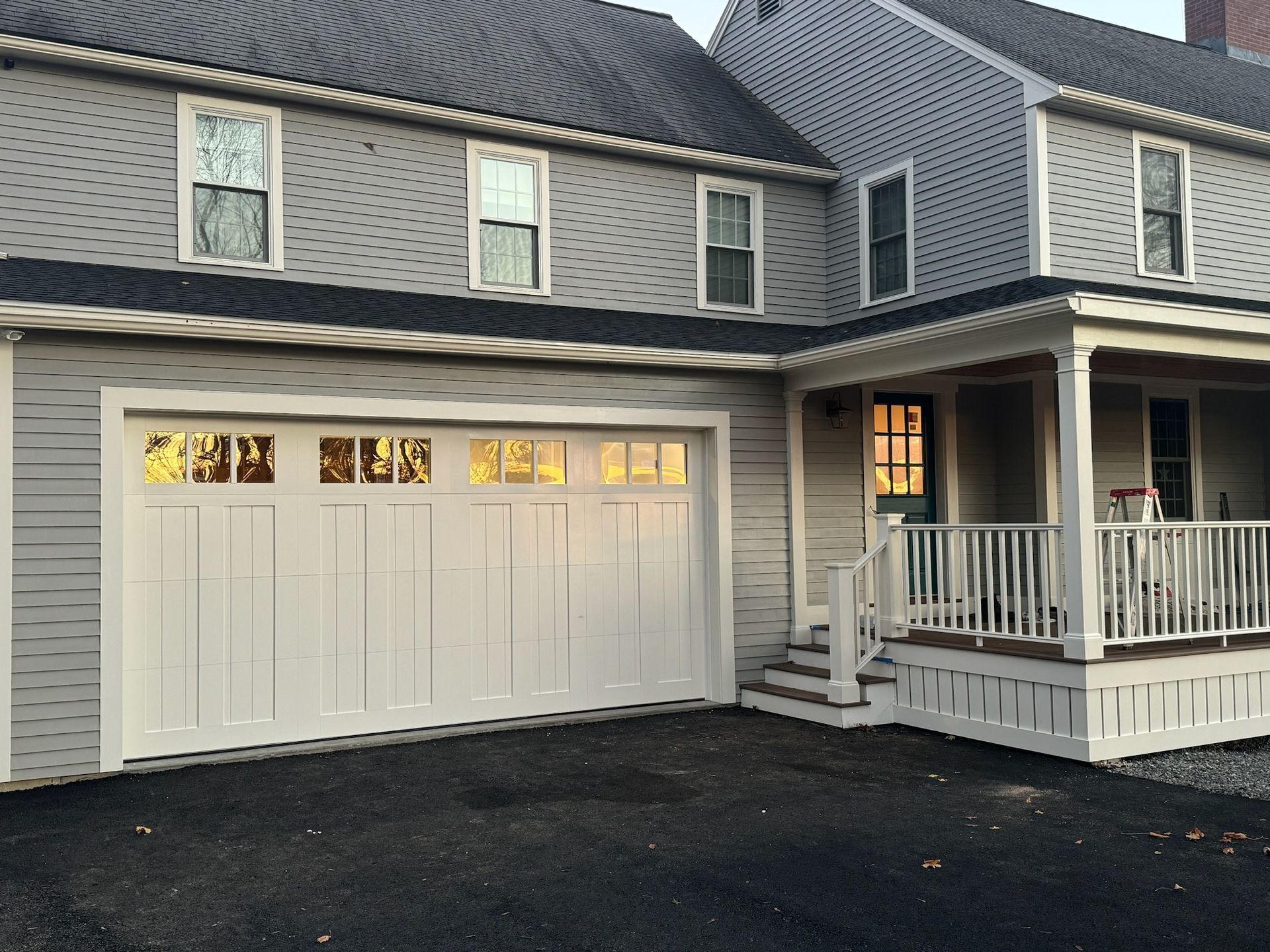 A house with a white garage door and a porch