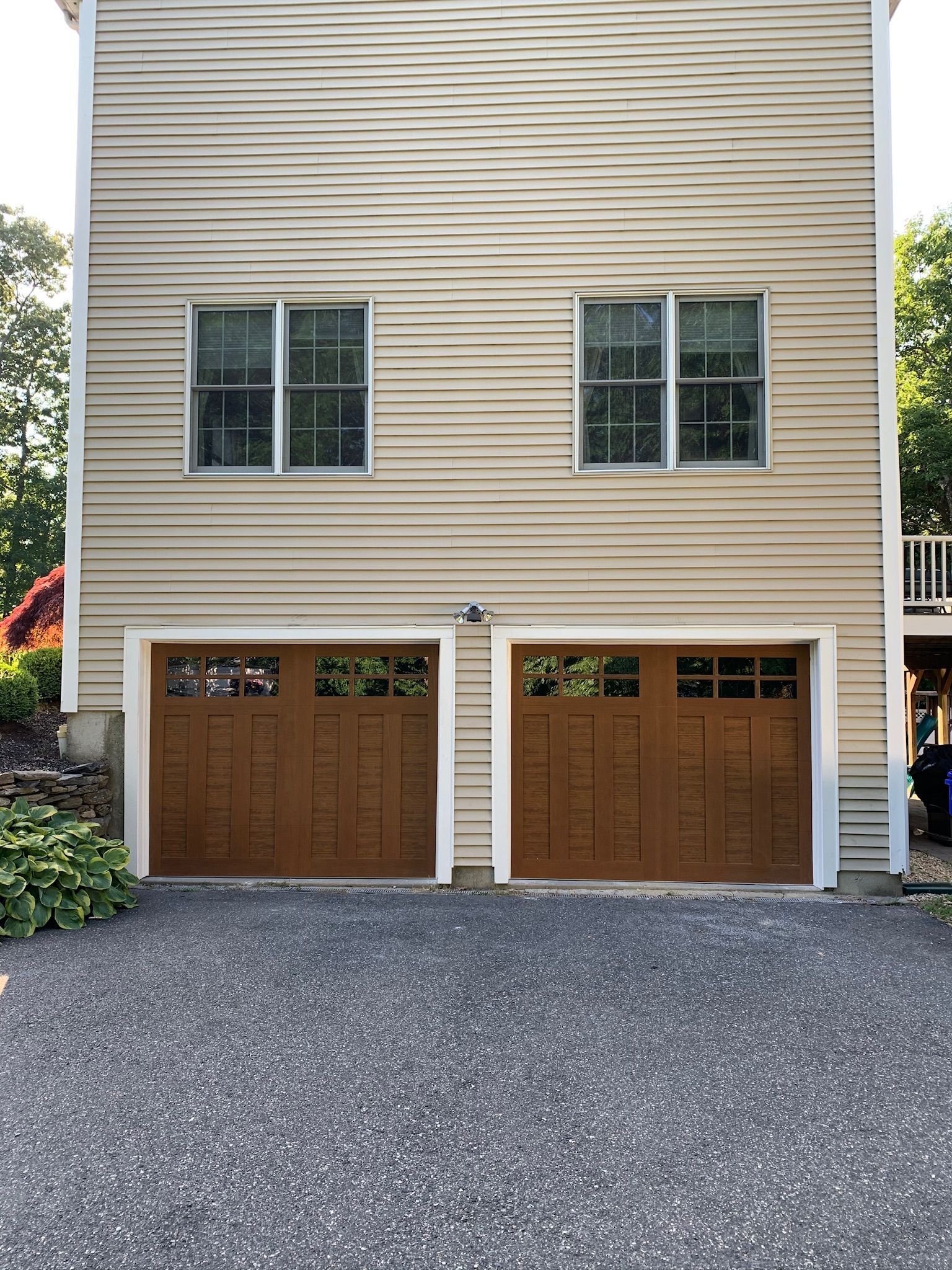 A house with two garage doors and two windows