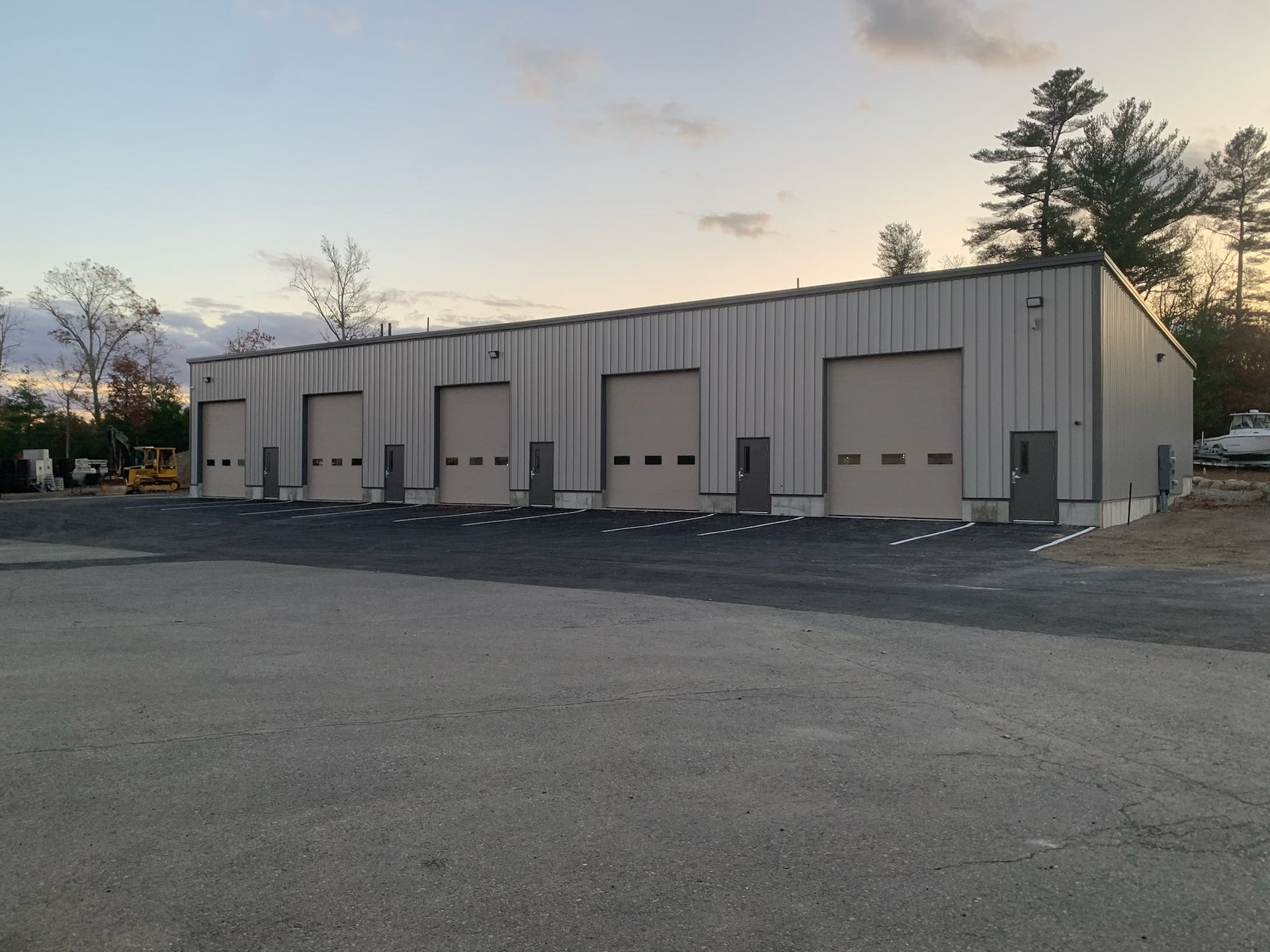 A row of garage doors are lined up in a parking lot