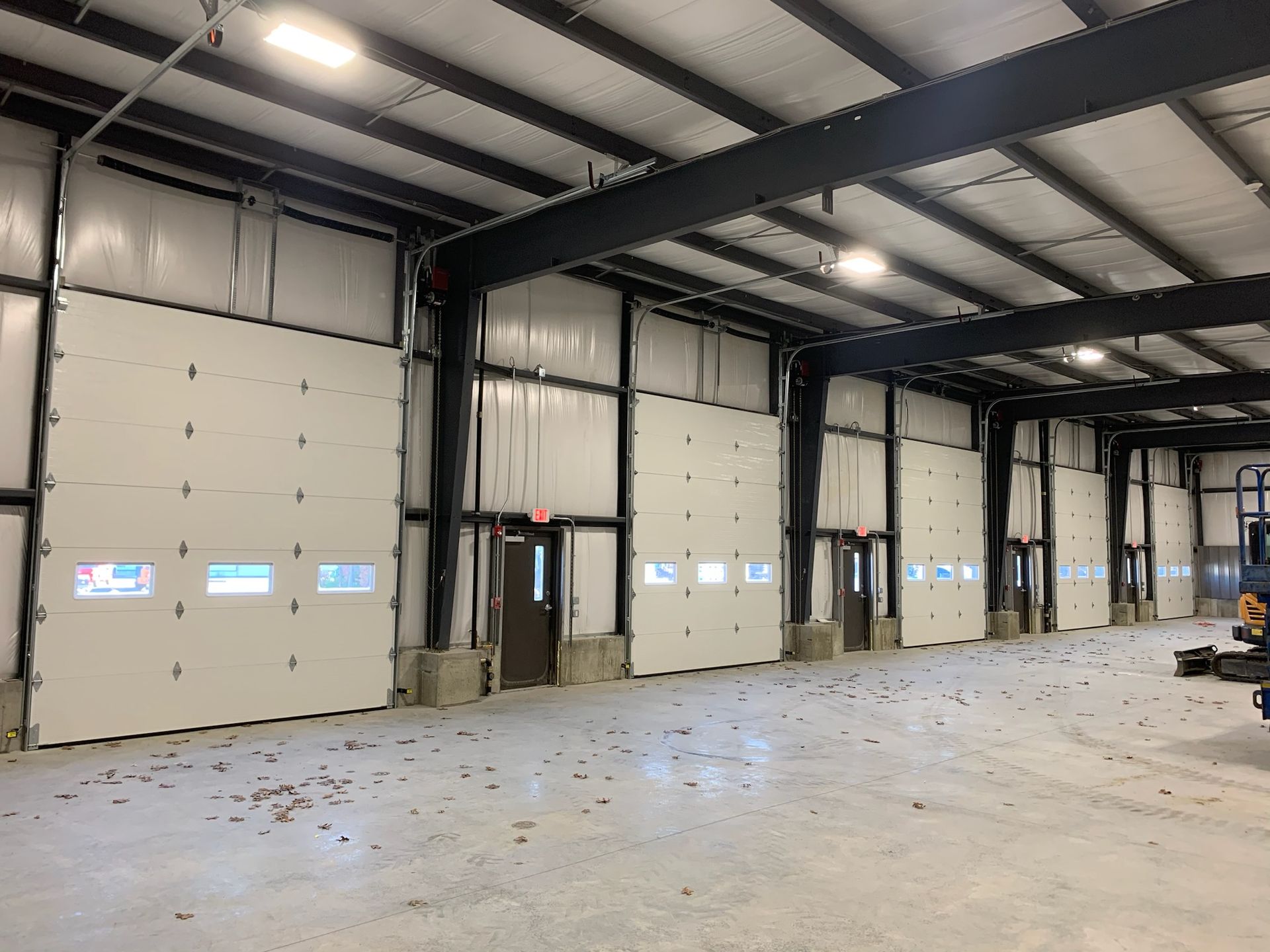 A large warehouse with a lot of doors and windows