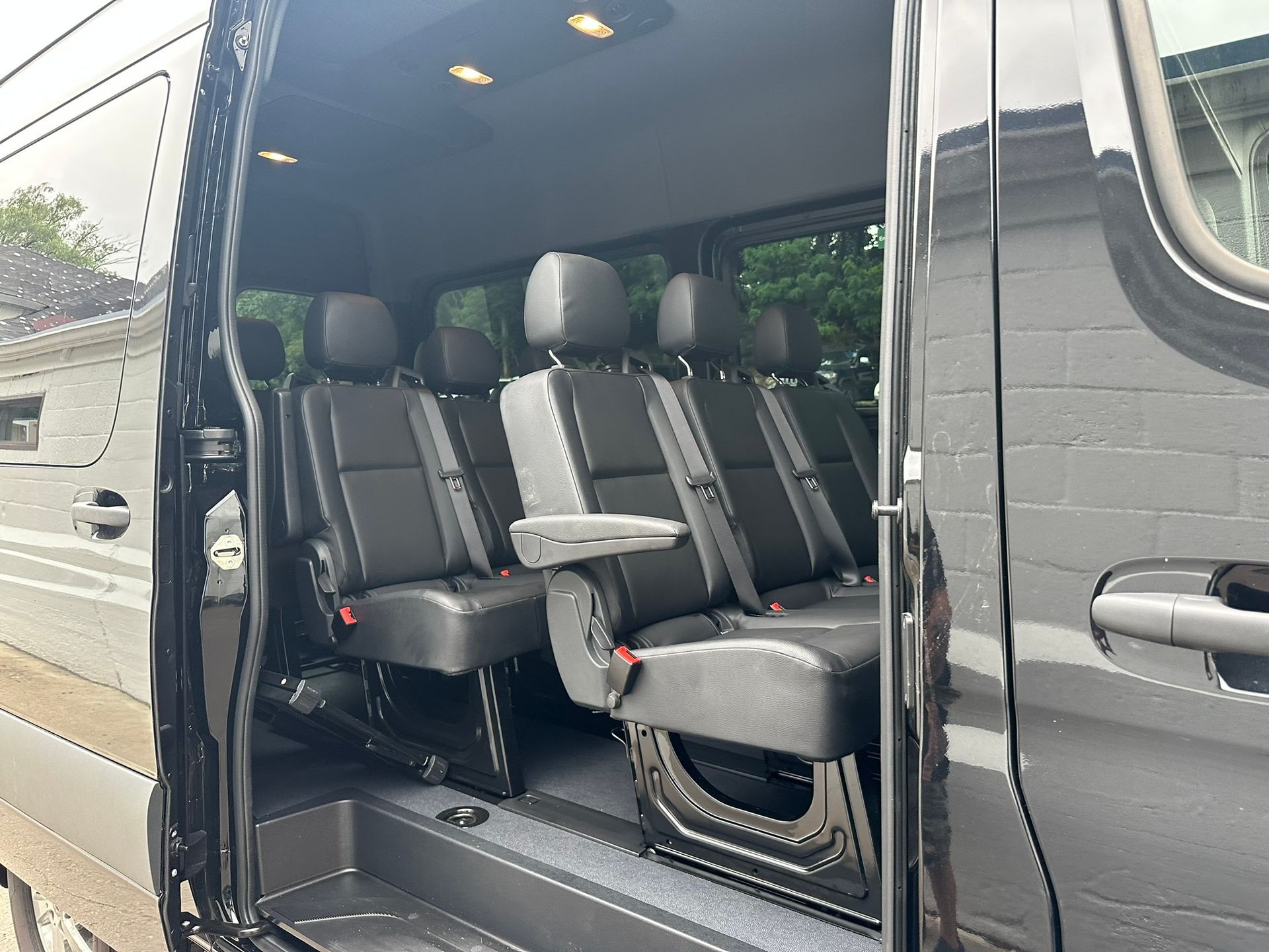 The inside of a black van with the door open.
