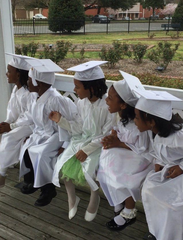 Kids with their graduation gown