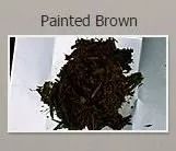 Pile of dark brown material on white paper, labeled