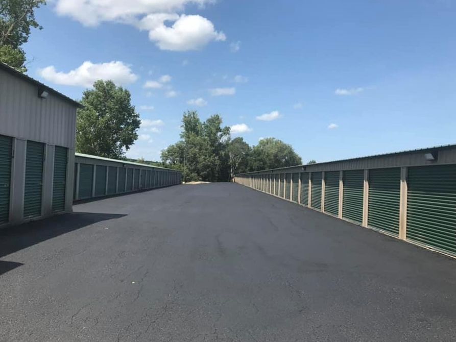 A row of storage units are lined up on the side of a road.