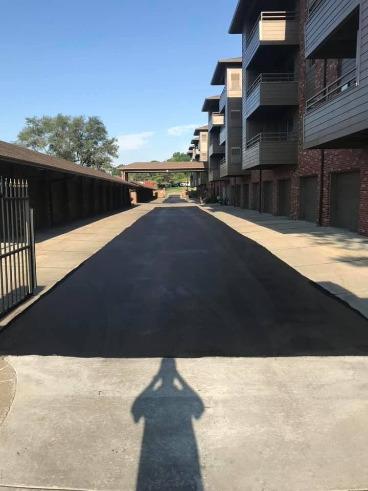 A shadow of a person is cast on the sidewalk in front of a building.