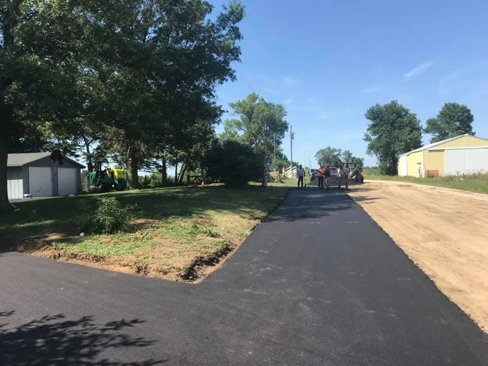 A group of people are standing on the side of a road.