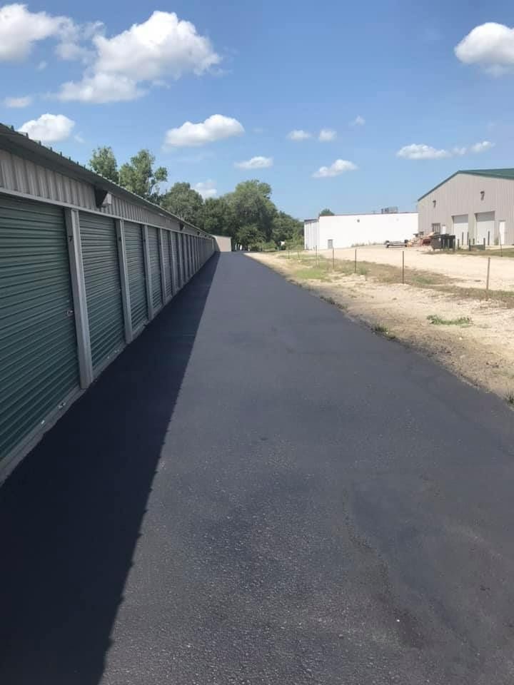 A row of storage units are lined up on the side of a road.