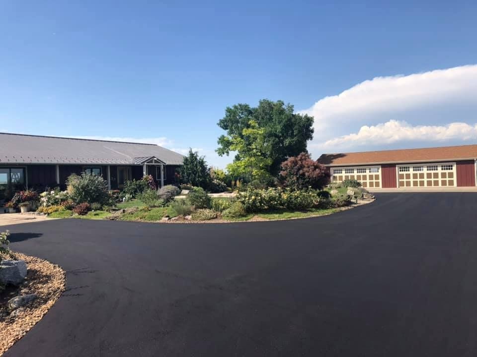 A large house with a large driveway in front of it.