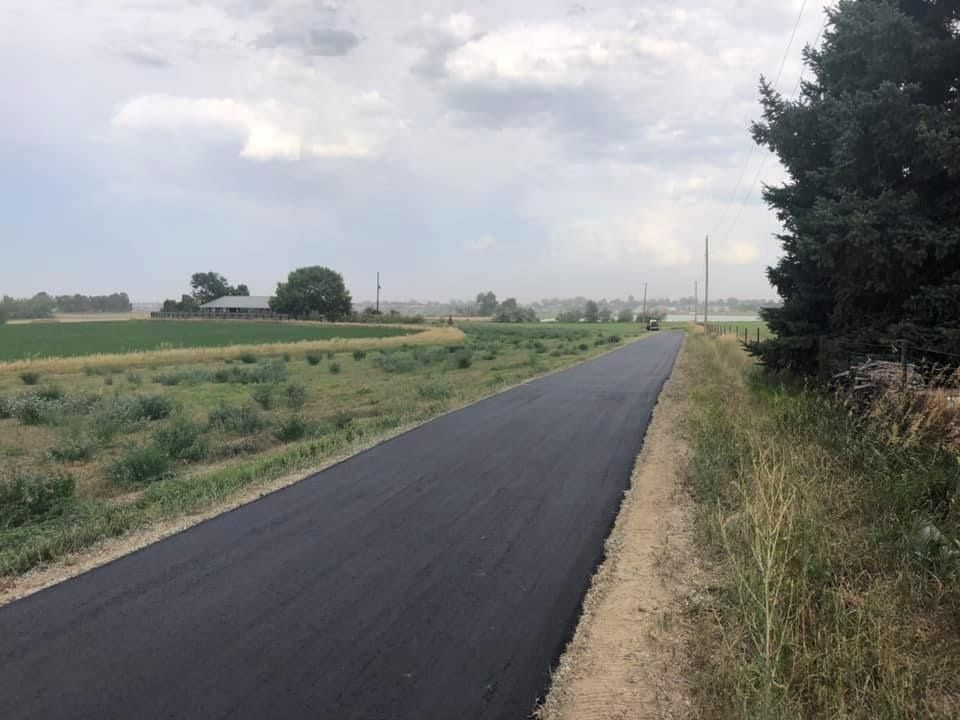 A road with a lot of grass on the side of it