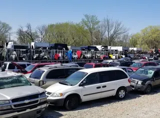 A lot of cars are parked in a lot.