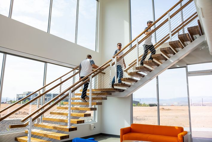 A group of people are walking up a set of stairs in a building.