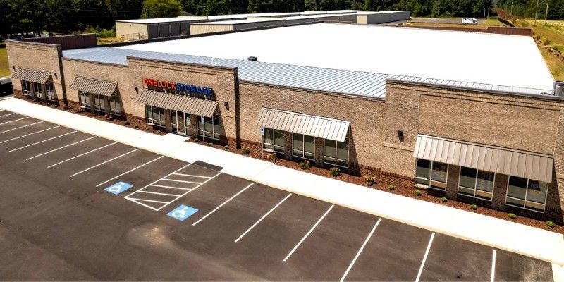 An aerial view of a large building with a white roof